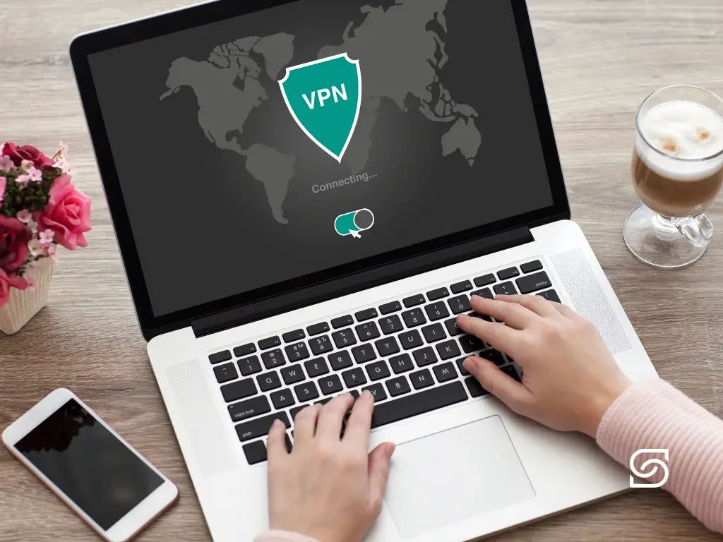 Person activating VPN on a laptop for secure remote work, featured in one of Sereno IT’s cybersecurity and managed IT support blogs.