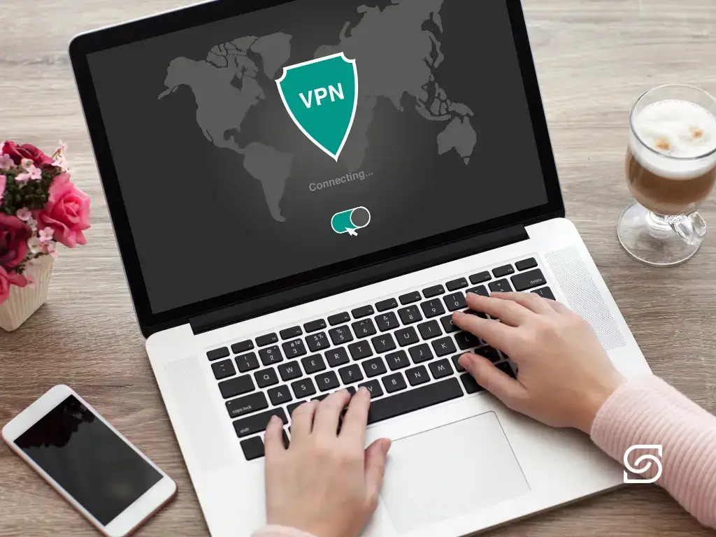 Person activating VPN on a laptop for secure remote work, featured in one of Sereno IT’s cybersecurity and managed IT support blogs.