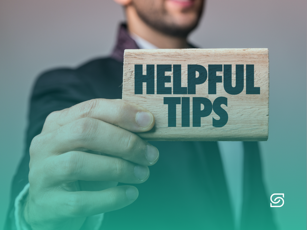 Business professional holding a sign reading 'Helpful Tips'.