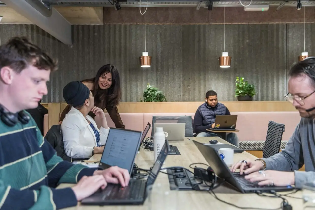 The Sereno IT team working together at laptops in their London office