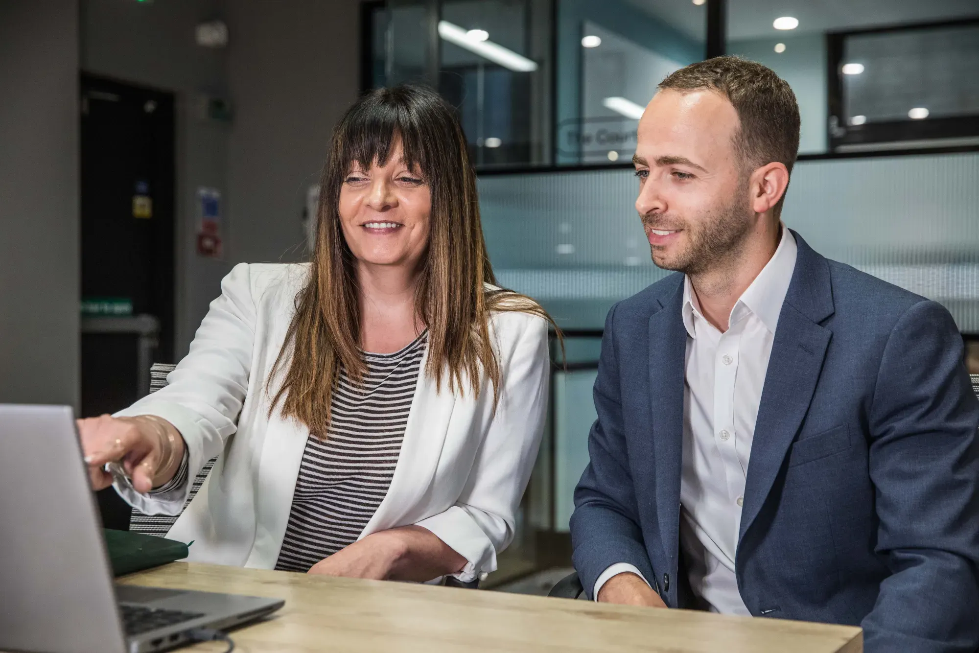 Sereno co-founders Elizabeth Procopiou and Michael Johnson reviewing work together at a laptop