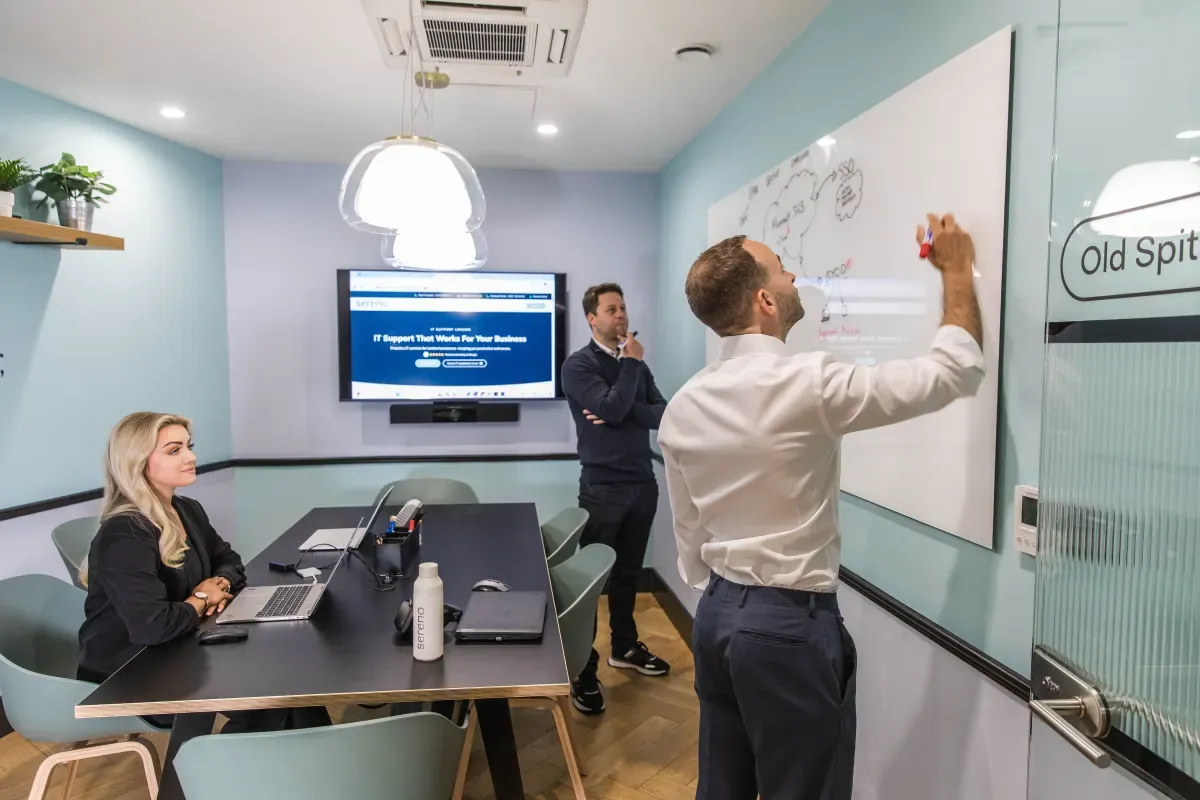 A Sereno engineer mapping out a solution on the whiteboard