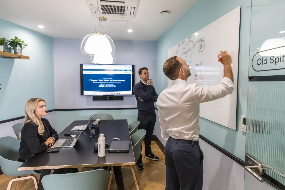 A Sereno engineer mapping out a solution on the whiteboard