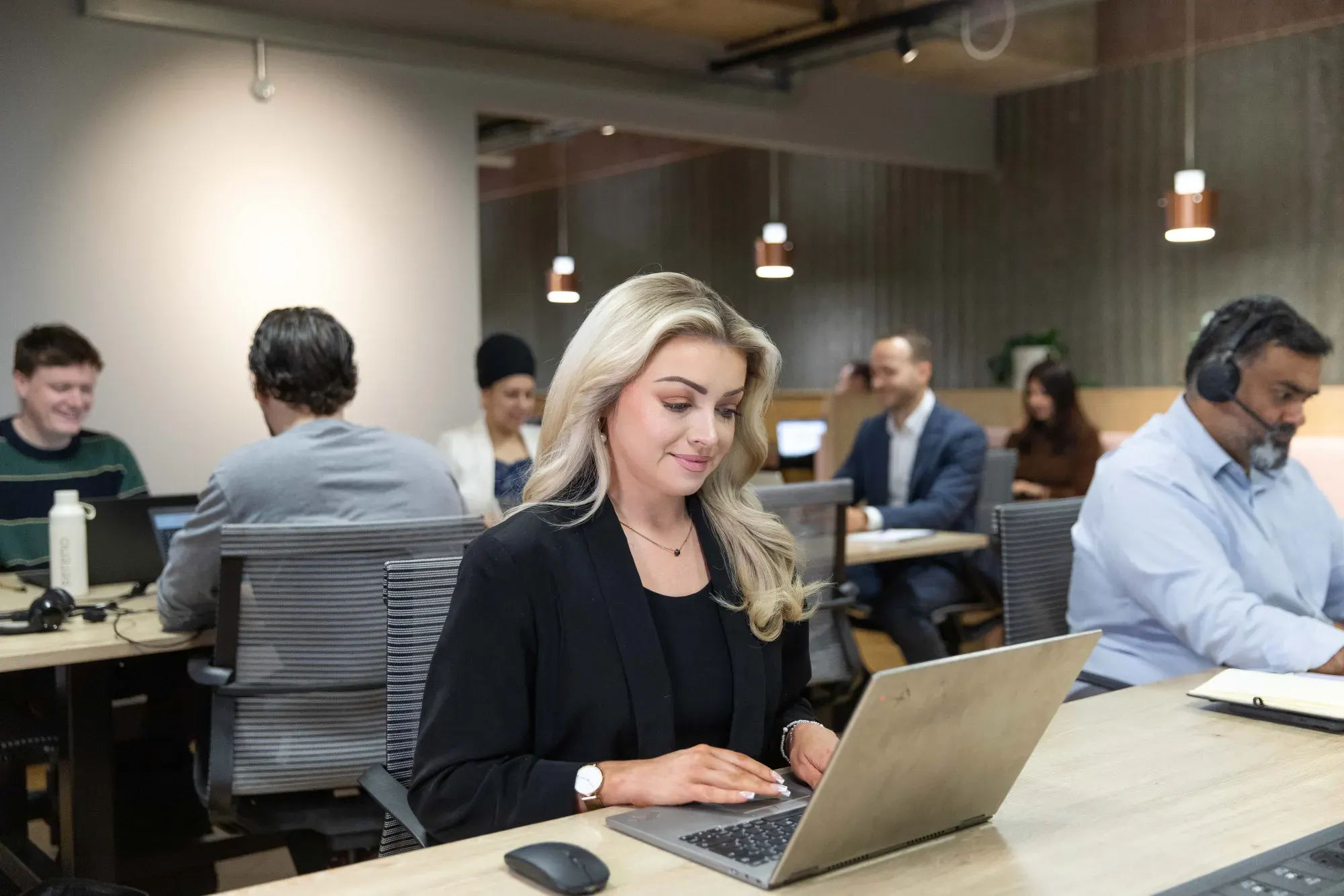 Sereno team members supporting clients from laptops in their London office